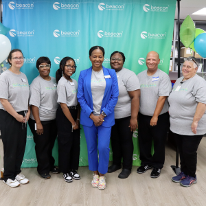 Beacon employees Amanda Fisher, Verna Paschal, Paige Goodman, LaTrice Snodgrass, Kayla Freeman, Will Hubert, and Toni King work a community outreach event to share their mission.